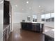 Modern kitchen featuring a center island with granite countertops, stainless steel appliances, and an open layout at 8236 E 137Th Dr, Thornton, CO 80602