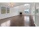 Open-concept living room featuring hardwood floors, a fireplace, and plenty of natural light at 8236 E 137Th Dr, Thornton, CO 80602