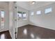 Bright room with three windows offering natural light and sleek dark hardwood floors at 8236 E 137Th Dr, Thornton, CO 80602