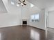 Expansive living room boasts a fireplace, hardwood floors, soaring ceilings, and large windows at 8236 E 137Th Dr, Thornton, CO 80602