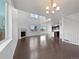 Spacious living area with fireplace, hardwood floors, large windows, and abundant natural light at 8236 E 137Th Dr, Thornton, CO 80602