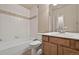 Bathroom featuring a tub, white tile and a wood-grain vanity at 16043 Bridle Ridge Dr, Monument, CO 80132