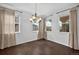Bright dining room featuring natural light, wood floors, neutral walls, and a decorative chandelier at 16043 Bridle Ridge Dr, Monument, CO 80132