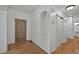 Inviting hallway features beautiful wood floors, a decorative front door, and a coat closet for storage at 16043 Bridle Ridge Dr, Monument, CO 80132