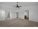 Spacious living room with neutral walls, a ceiling fan, and an open floor plan with archways to other rooms at 16043 Bridle Ridge Dr, Monument, CO 80132