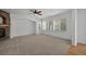 Carpeted living room with a stone fireplace and large windows at 16043 Bridle Ridge Dr, Monument, CO 80132