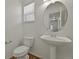Cozy powder room with a modern sink, sleek faucet, and window for natural light, and a toilet at 16043 Bridle Ridge Dr, Monument, CO 80132