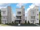 Modern townhomes with sleek design, featuring mixed materials, windows, and professional landscaping at 1218 Dylan Dr, Erie, CO 80026