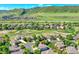Scenic aerial shot of the home nestled in a serene, tree-lined neighborhood with rolling hills in the background at 8427 S Parfet Ct, Littleton, CO 80127