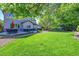 Spacious backyard with a lush green lawn, a patio, and beautiful landscaping perfect for outdoor entertaining and relaxation at 8427 S Parfet Ct, Littleton, CO 80127
