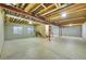 Spacious unfinished basement with concrete floor, exposed ceiling, and roughed in plumbing ready for customization at 8427 S Parfet Ct, Littleton, CO 80127