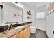 Clean bathroom with stone vanity, floating shelves, and modern fixtures at 8427 S Parfet Ct, Littleton, CO 80127