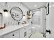 Updated bathroom boasts stunning tile, a sleek vanity and modern fixtures at 8427 S Parfet Ct, Littleton, CO 80127