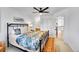 Comfortable bedroom with ceiling fan, a bed and easy access to the hallway at 8427 S Parfet Ct, Littleton, CO 80127