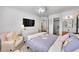 Bright bedroom featuring a television, a dresser, and a plush armchair at 8427 S Parfet Ct, Littleton, CO 80127