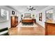 Inviting bedroom features a ceiling fan, hardwood floors, and natural light at 8427 S Parfet Ct, Littleton, CO 80127
