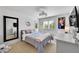 Comfortable bedroom with white walls, carpeted floors, and a decorative light fixture at 8427 S Parfet Ct, Littleton, CO 80127