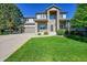 Charming two-story home with a well-manicured lawn and a stone columned porch at 8427 S Parfet Ct, Littleton, CO 80127