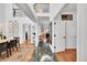 Bright foyer features soaring ceilings, a curved staircase, and views into the living spaces at 8427 S Parfet Ct, Littleton, CO 80127