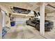 Well-organized garage with a storage rack, an electric door, and enough space to park a car and other items at 8427 S Parfet Ct, Littleton, CO 80127