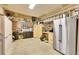 Well-organized garage with tool racks, workbench, cabinets, and a full-size refrigerator for added convenience at 8427 S Parfet Ct, Littleton, CO 80127