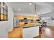 Bright kitchen with stainless steel appliances, granite countertops, and light wood cabinets at 8427 S Parfet Ct, Littleton, CO 80127