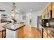 Open kitchen with granite countertops, stainless steel appliances, and hardwood floors at 8427 S Parfet Ct, Littleton, CO 80127