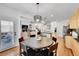 Open living space with dining area and kitchen in the background, stairs up at 8427 S Parfet Ct, Littleton, CO 80127