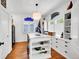 Bright home office featuring custom built-ins, an island work space and natural light at 8427 S Parfet Ct, Littleton, CO 80127