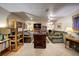 Spacious basement featuring multiple seating areas, shelves, entertainment center, and neutral color scheme at 283 Yank Ct, Lakewood, CO 80228
