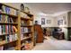 Basement with built-in bookshelves, an antique desk, a printer, and decorative items creating a functional area at 283 Yank Ct, Lakewood, CO 80228