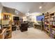Finished basement featuring a fireplace, TV, shelving, and cozy seating areas at 283 Yank Ct, Lakewood, CO 80228