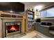 Finished basement with a fireplace, TV, shelving, and a cozy seating area at 283 Yank Ct, Lakewood, CO 80228