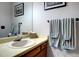 Bathroom vanity features a sink, and a mirror, adorned with soft-colored towels at 283 Yank Ct, Lakewood, CO 80228