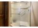 Bathroom featuring a glass-enclosed shower with tiled walls and safety hand rails at 283 Yank Ct, Lakewood, CO 80228