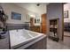 Bright bathroom with a large jacuzzi tub, wooden cabinets, and stylish tile flooring at 283 Yank Ct, Lakewood, CO 80228