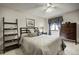 Cozy bedroom features a comfortable bed, ceiling fan, soft lighting, and dark wood furniture at 283 Yank Ct, Lakewood, CO 80228