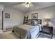 Bedroom featuring a comfortable bed, ceiling fan, soft lighting, and dark wood furniture at 283 Yank Ct, Lakewood, CO 80228