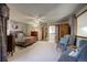 Spacious bedroom with neutral carpet, inviting armchairs, and a connecting ensuite at 283 Yank Ct, Lakewood, CO 80228