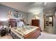 Serene bedroom with soft carpet, neutral gray wall, and an inviting bed with a patterned quilt at 283 Yank Ct, Lakewood, CO 80228