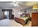 Bedroom featuring a wooden bed frame, plush carpet, and sliding glass doors to the outside at 283 Yank Ct, Lakewood, CO 80228