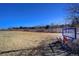 Scenic view of community open space and manicured lawns, with a sign and residential buildings in the distance at 283 Yank Ct, Lakewood, CO 80228
