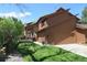 Two-story brown home with a manicured lawn, attractive landscaping and a cozy deck at 283 Yank Ct, Lakewood, CO 80228