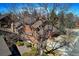 Exterior view showcases the architecture nestled among mature trees and manicured landscaping at 283 Yank Ct, Lakewood, CO 80228