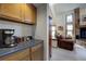 Bright kitchen nook with modern appliances, wooden cabinets, and a view of the living room at 283 Yank Ct, Lakewood, CO 80228
