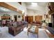 Open-concept living room with a fireplace, skylights, and an adjacent dining area at 283 Yank Ct, Lakewood, CO 80228