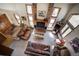 Aerial view showcasing the living room with a brick fireplace, multiple windows, and leather sofas at 283 Yank Ct, Lakewood, CO 80228