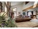 Spacious living room with high ceilings, large windows, and comfortable leather furniture at 283 Yank Ct, Lakewood, CO 80228