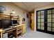 Home office features a built-in desk, carpeted floors and a view of a decorative glass door at 283 Yank Ct, Lakewood, CO 80228