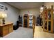 Home office features neutral carpet and wooden desk, shelving and organizational features at 283 Yank Ct, Lakewood, CO 80228